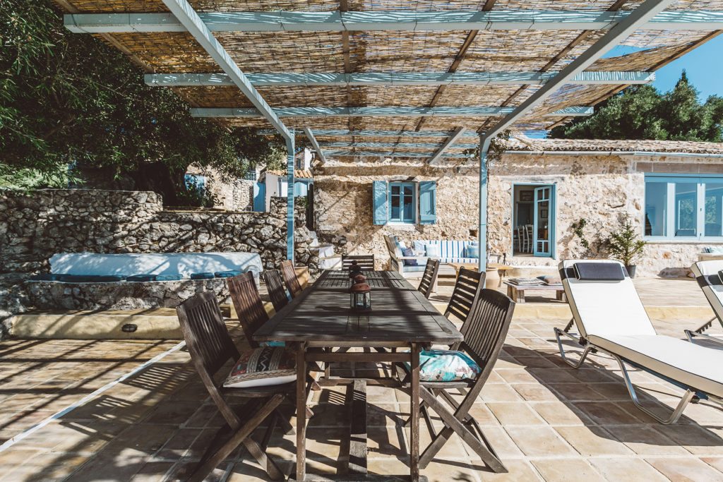 Outdoor dining area of Xyloporta, a luxury Greek island villa with a pool near The Peligoni Club