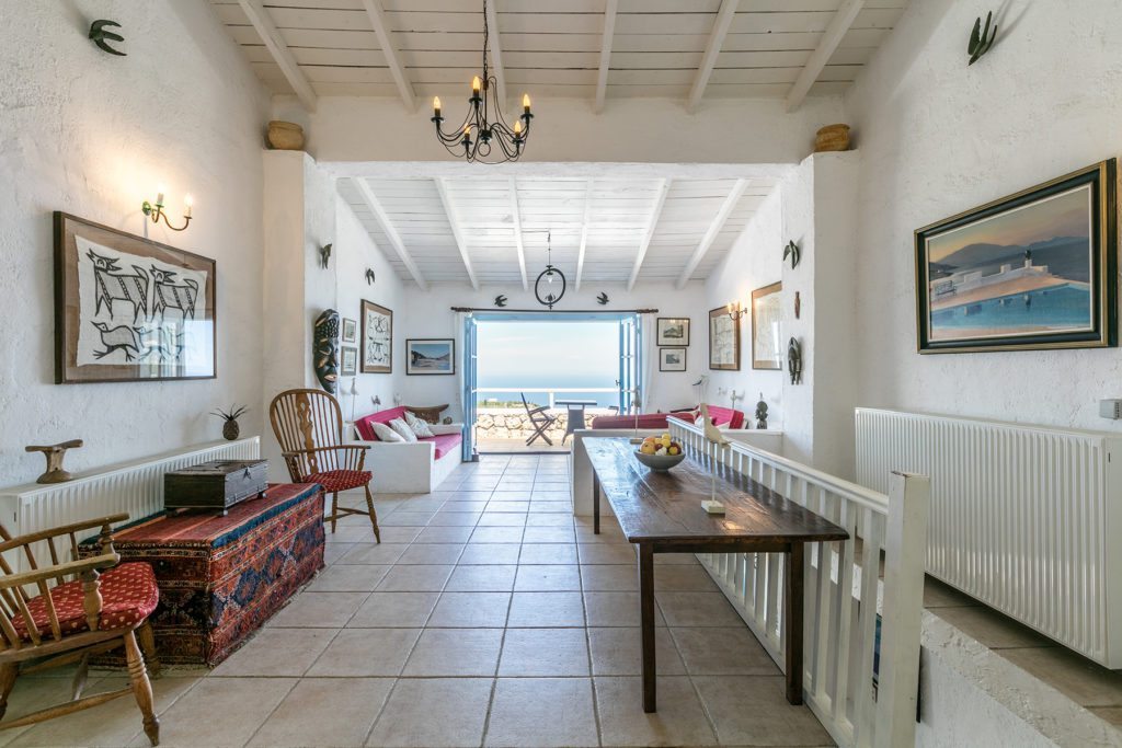 Stone floors and white wooden ceilings in the hallway of the rustic style villa Tal Hamsa