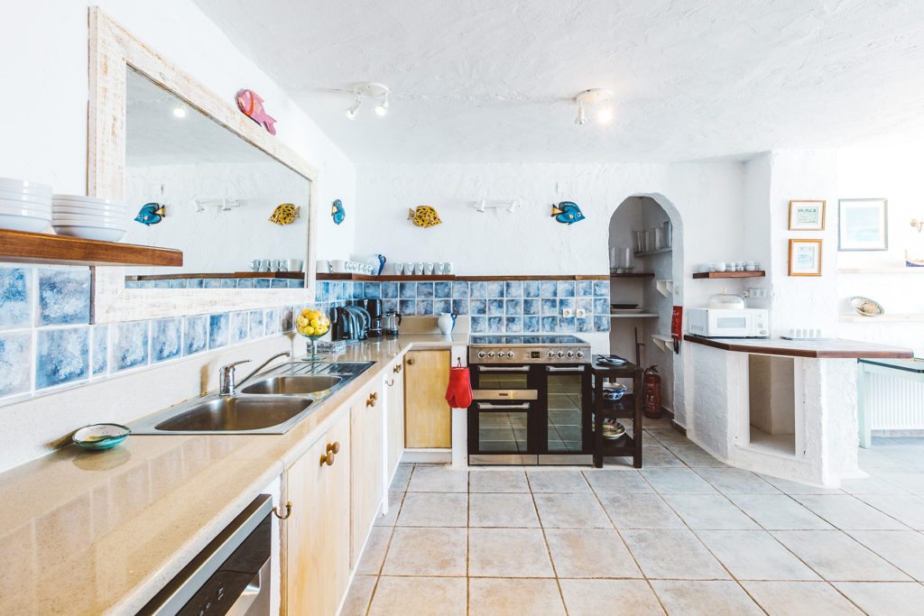 Open plan kitchen area with traditional Greek tiling