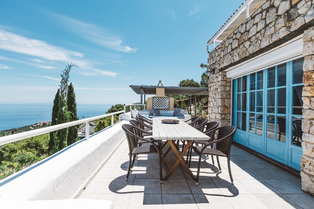 Outdoor dining table with views of Greek countryside and blue skies