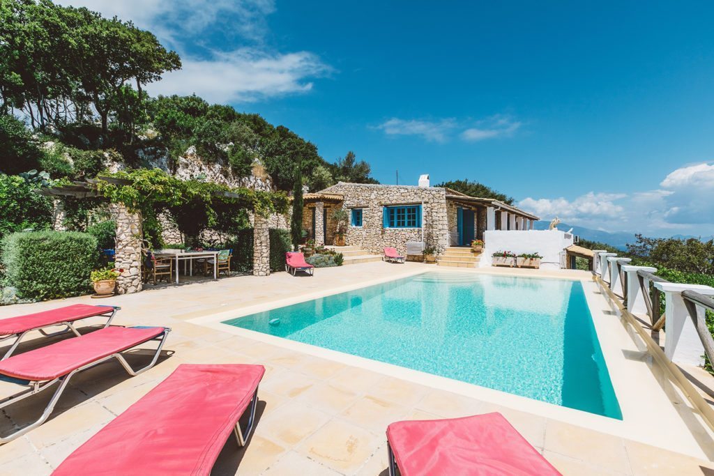pool with sun beds and the a view of the Yerakina villa