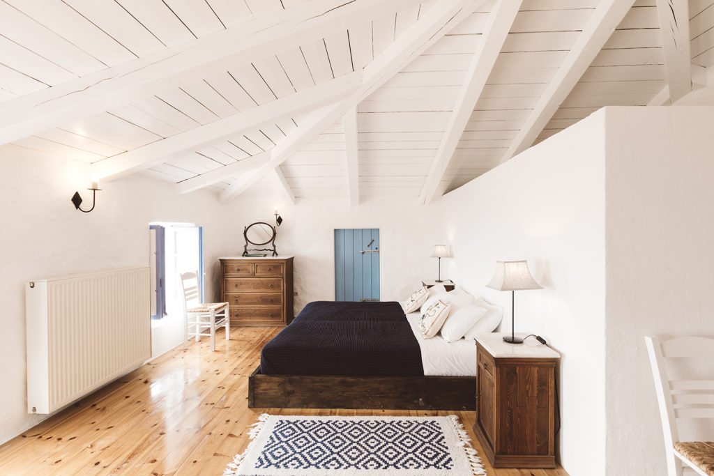 Master bedroom with white wooden beamed ceiling in the 9 bedroom traditional greek villa with a pool and sea view near The Peligoni Club in North Zakynthos Greece