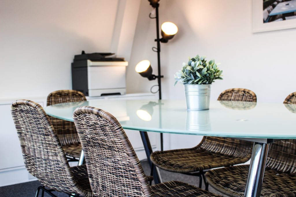 Wicker chairs and modern in office with white walls with modern floor lamp