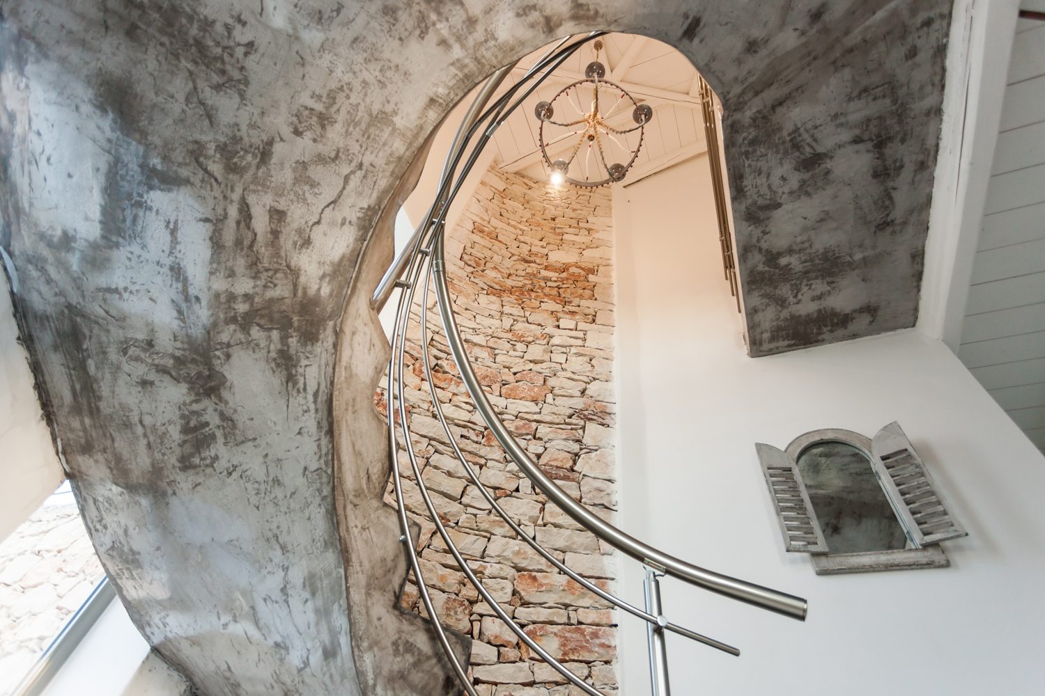 Spiral stone staircase in Amoulakis luxury villa Greece with The Peligoni Club