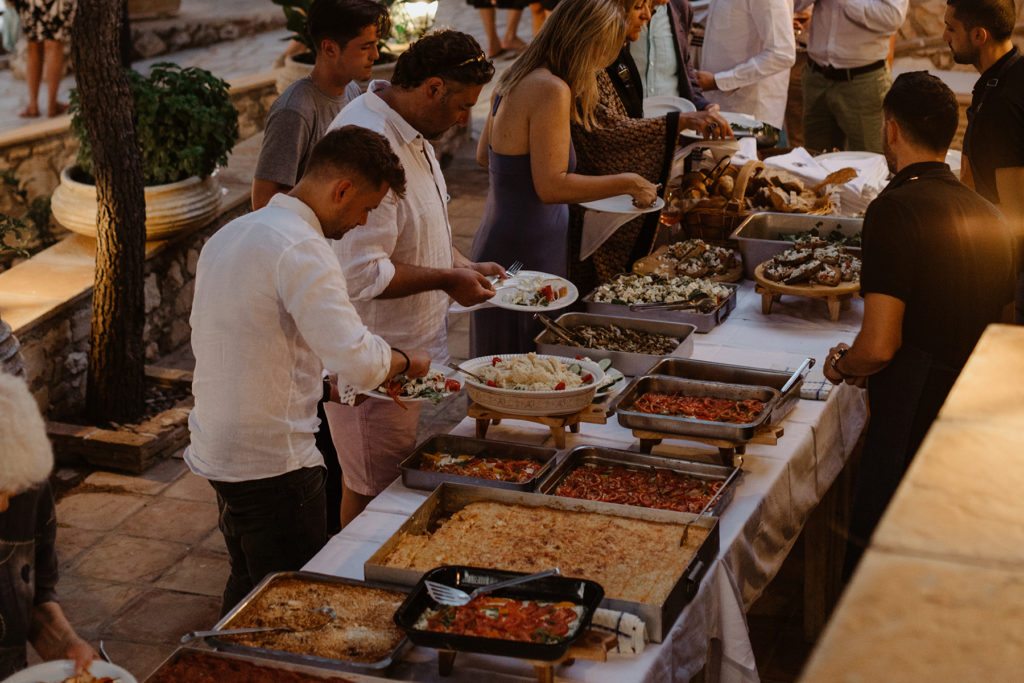 Guests serve themselves local greek cuisine from a freshly prepared buffet